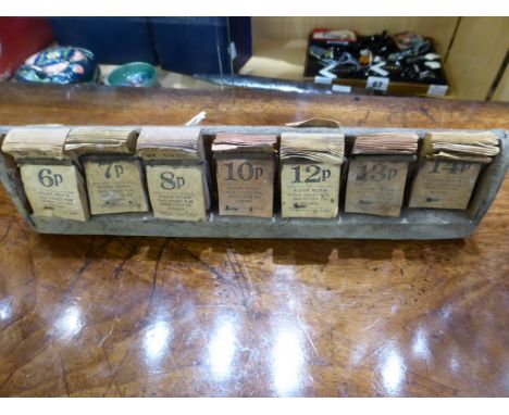 A vintage 1970's Guernsey Bus wooden ticket rack containing unused tickets.