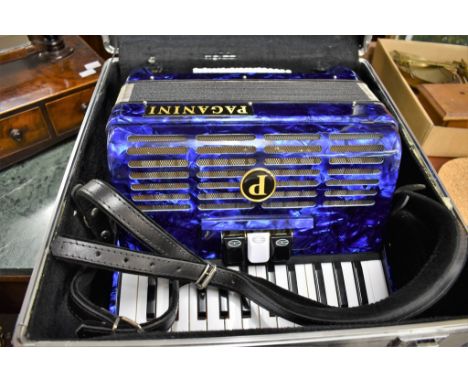 A Paganini 48 bass accordion. Cased.