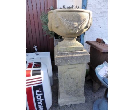 A composite stone planter and pedestal