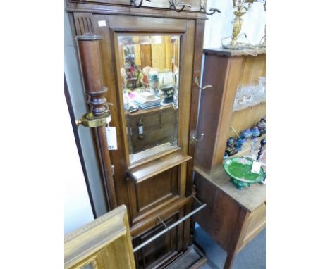 A vintage coat, hat and stick stand with mirror and shelf.