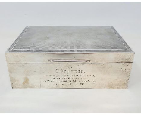 A large table cigarette box, the lid with engine turned decoration, the front with a presentation inscription dated 1935, Lon