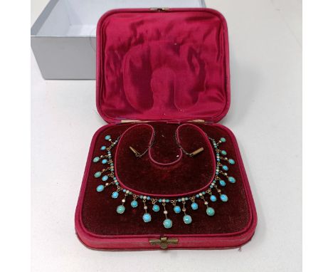 A turquoise and seed pearl necklace, fitted in a silk box 