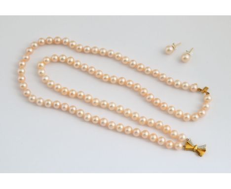 A two strand cultured pink pearl necklace, with a 14ct gold clasp, and matching earrings, in a Thalia Tati box 