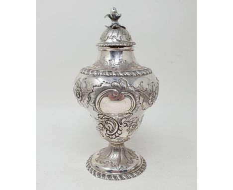 A George III silver tea caddy and cover, of vase form, embossed a bird, flowers and foliage, London 1770, 7.4 ozt, 17 cm high