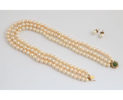 A three strand cultured pearl necklace, with an emerald and diamond clasp, and matching earringsThe pearls are uniform size, 