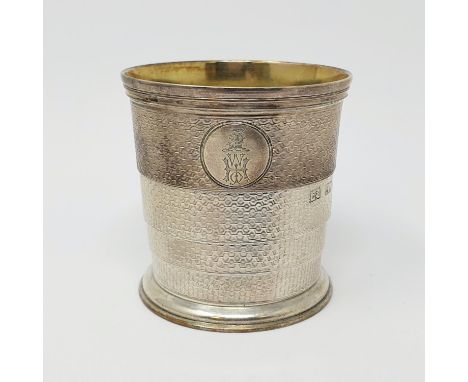 A Victorian silver collapsible cup, crested and initialled, and with engine turned decoration, London 1868, 3.1 ozt, 6.5 cm d