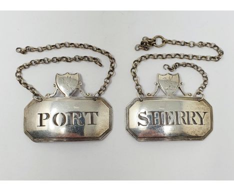 An unusual pair of silver decanter labels, Sherry &amp; Port, surmounted by cartouches which are crested, 4.5 cm wide (2)