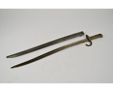 A French Yataghan bayonet and scabbard, inscribed to the spine of the blade and dated 1867, the bayonet and scabbard have the