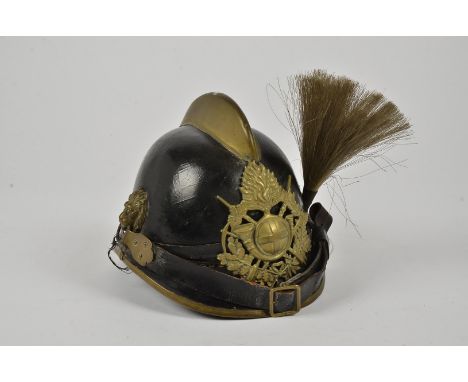 A 19th Century German helmet, possibly Fire Fighters, having small brass comb, with wreath, fuse, bugle and crossed rifle hel