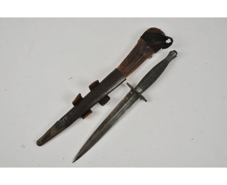 A Fairbairn Sykes fighting dagger, unmarked to the cross guard or handle, together with leather scabbard, AF (2)