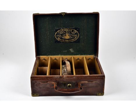 A Harrods Gun & Rifle Dept ammunition case, having four compartments with leather inserts, together with a Stephen Grant Gun 