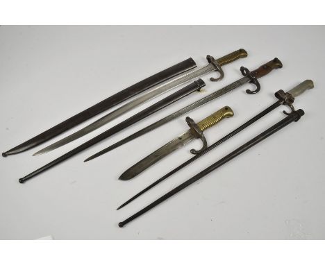 A group of four French bayonets, including a Yataghan with steel scabbard, a lebel with cruciform blade and steel scabbard, a