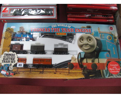 A 'OO' Scale 'Thomas The Tank Engine' Set by Hornby, comprising 0-6-0 'Thomas', three wagons, two coaches:- Boxed with track.