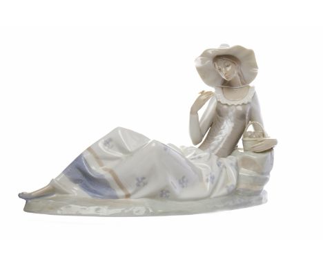 NAO RECLINING FEMALE FIGURE IN COUNTRY DRESS
modelled as a woman holding a basket, approximately 22cm high