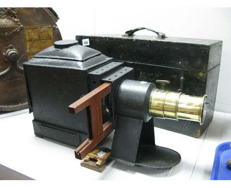 A Victorian Magic Lantern, complete with interior fittings, lantern slide, etc, together with its original pine carry case. 