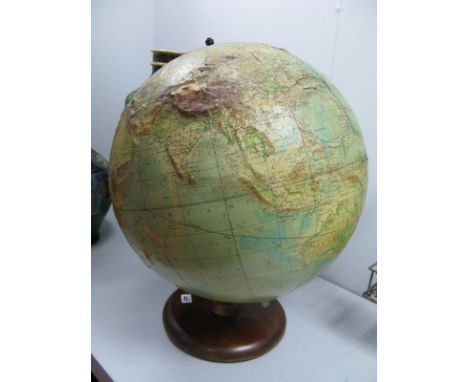 A Large Philip's Terrestrial Globe, (19" diameter), dated 1958 with raised surfaces showing mountainous areas on a wooden bas