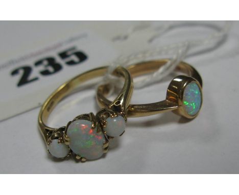 A 9ct Gold Three Stone Opal Ring, oval claw set to the centre, between two circular cabochon opals; together with a single st