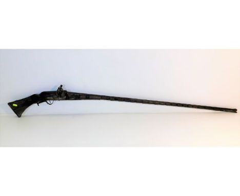 A 19thC. Asian, probably Indian, flintlock rifle 62.25in long 