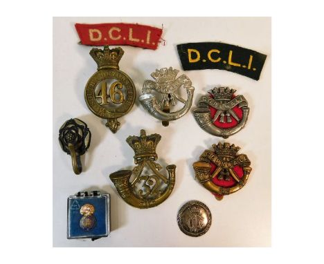 A quantity of DCLI &amp; other regiment badges including South Devonshire. Provenance: Submitted by Mrs. Lauraine Sadleir MBE