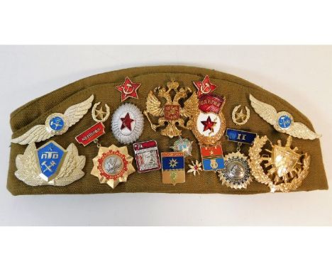 A Russian beret with a collection of badges. Provenance: Submitted by Mrs. Lauraine Sadleir MBE &amp; the late Mr. Michael R.