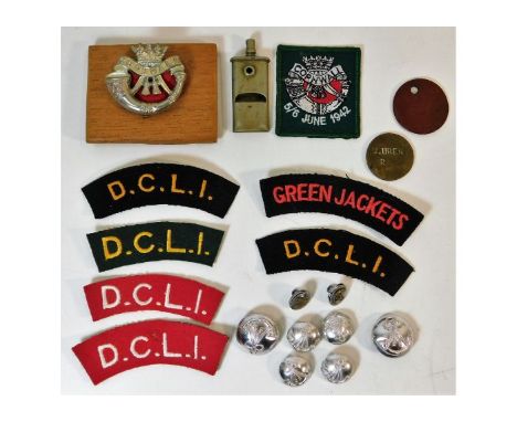 A WW1 trench art whistle twinned with DCLI related badges &amp; buttons. Provenance: Submitted by Mrs. Lauraine Sadleir MBE &