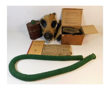 A 1938 British respirator, a civilian gas mask in original box &amp; safety books. Provenance: Submitted by Mrs. Lauraine Sad