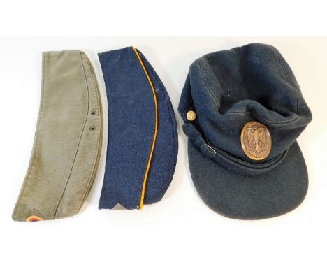 A German field hat &amp; two German berets. Provenance: Submitted by Mrs. Lauraine Sadleir MBE &amp; the late Mr. Michael R. 