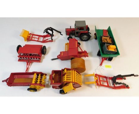 A quantity of Britains farm equipment, used for the catalogue photos in the late 1970's