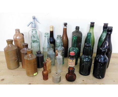 A quantity of vintage stoneware &amp; glass bottles inc. a soda syphon