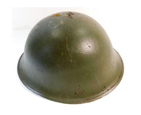 A WW2 British army steel helmet MkIII 1944 Normandy pattern. Provenance: Submitted by Mrs. Lauraine Sadleir MBE &amp; the lat