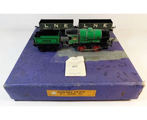A Hornby 'O' gauge tinplate clockwork railway engine with tender &amp; two carriages, box a/f