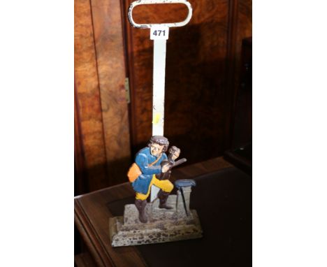 Cast metal door stop with figure playing violin. 49cm high