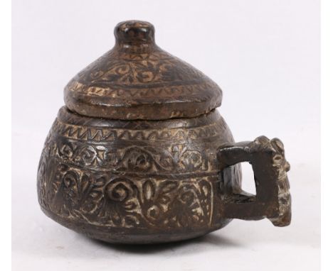 A rare and unusual Inca glazed earthenware jar and cover, perhaps 16th century , incised with ornament in a geometric pattern