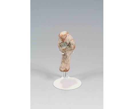 Egyptian terracotta ShabtiNew Kingdom, C. 1100 B.C.The figure is depicted in mummiform position showing agricultural tools be