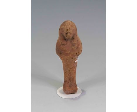 Egyptian Pottery ShabtiNew Kingdom, 19th Dynasty.A mould-made mummiform worker  figure with traces red-brown slip. Has tripar