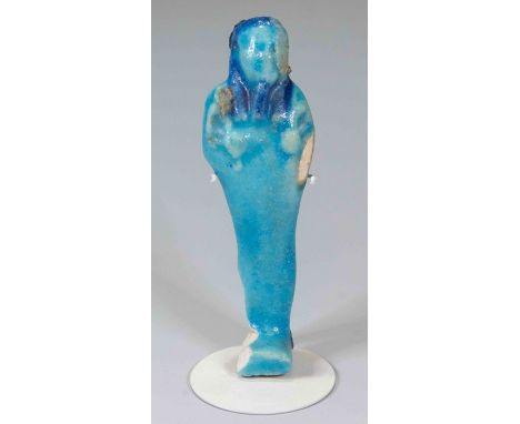Egyptian Faience Turquoise ShabtiPtolemaic Period, circa 300 BC.A bright turquoise shabti with bright blue wig and clear deta
