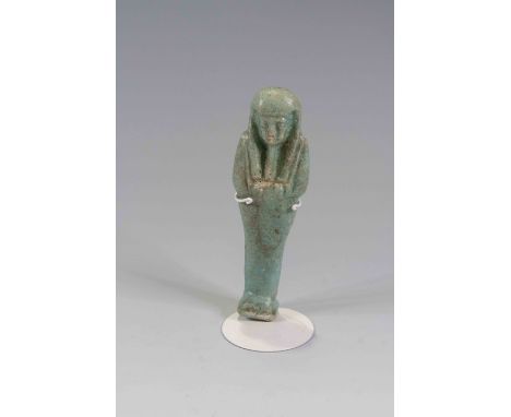 Egyptian Faience ShabtiLate Period, c. 525 B.C.The figure is depicted in mummiform position showing agricultural tools betwee