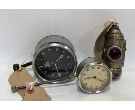 A vintage carbon rear lamp and two car clocks