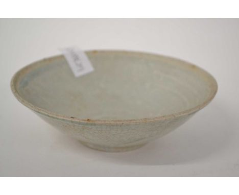 A Chinese pottery bowl possibly Song Dynasty with a celladon type light glaze, 17cm diameter