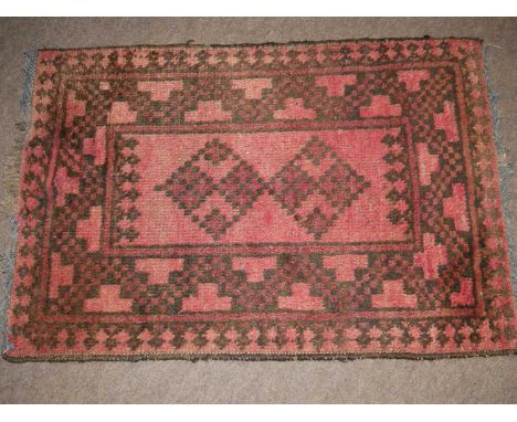 Small Middle Eastern wool prayer mat, decorated with geometric design on a red background, 72cm wide