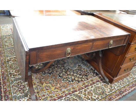 A Georgian mahogany sofa or centre table of typical form with drop leaves, two drawers and two dummy drawers raised on turned