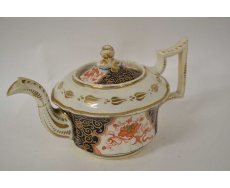 An early 19th century English porcelain teapot and cover possibly Newhall or Rockingham, with a hand painted Imari design the