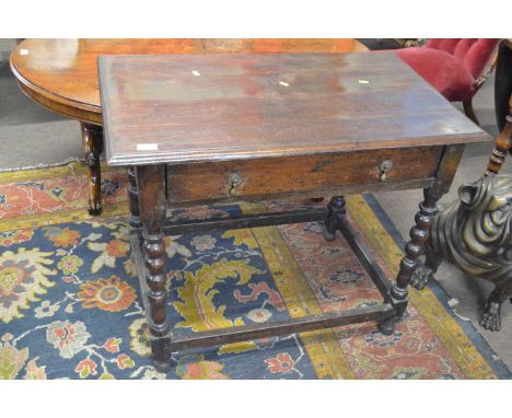 A late 17th or early 18th Century oak side table with single drawer raised on a bobbin turned frame with base stretcher, 86cm