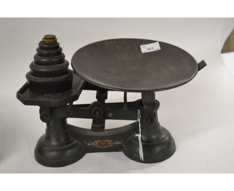 A vintage pair of scales with associated weight, marked A1 Exchanges, Norwich