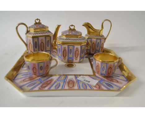 A continental porcelain cabaret set, probably Paris comprising octagonal tray with teapot, sugar bowl, milk jug and two cups,