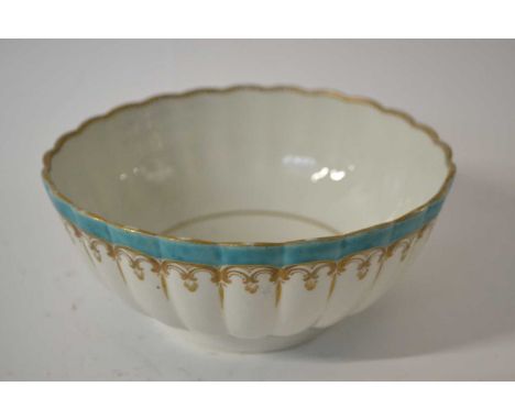 An 18th Century Worcester bowl of ribbed form decorated in gilt within turquoise borders, 17cm diameter