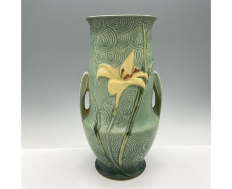 Matte finish over water ripple design, pink and yellow raised lily with light green background. Small dual handles accent vas
