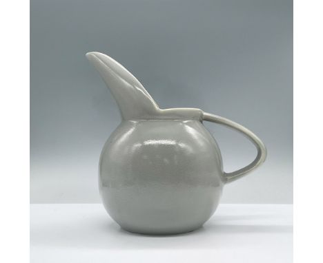 Features a glossy textured ceramic pitcher with a long spout. It has The Paden City Pottery back stamp. Issued: 20th centuryD