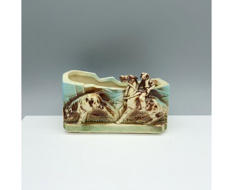 Sublime vintage plant holder that depicts a cowboy roping a cow. McCoy backstamp on base. Issued: c. 1950sDimensions: 7.75"L 