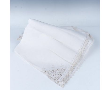 Beautiful hand-embroidered Italian linen tablecloth in white, featuring intricate drawn thread and cutout embroidery in a del